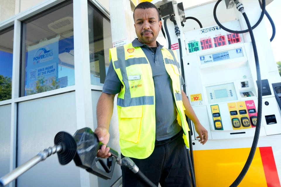 Ismail Ait Yichou places the nozzle into a car at a Shell station on Route 17 South in Ridgewood, Thursday, August 31, 2023.