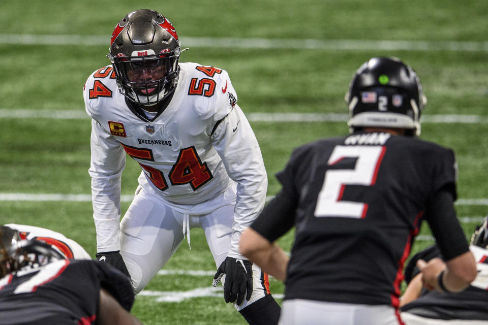 FILE - In this Sunday, Dec. 20, 2020 file photo, Tampa Bay Buccaneers inside linebacker Lavonte David (54) lines up during the second half of an NFL football game against the Atlanta Falcons in Atlanta. Applying franchise and even transition tags to players can have major ramifications on a team's present and future. That was never more of a consideration than this year, with the salary cap decreasing by, for now, $18 million. That's the first time the cap has gone down, which is due to lost revenues caused by the COVID-19 pandemic. (AP Photo/Danny Karnik, File)