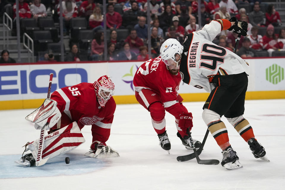 Detroit Red Wings goaltender Ville Husso (35) stops a Anaheim Ducks left wing Pavol Regenda (40) shot as Filip Hronek (17) defends in the first period of an NHL hockey game Sunday, Oct. 23, 2022, in Detroit. (AP Photo/Paul Sancya)