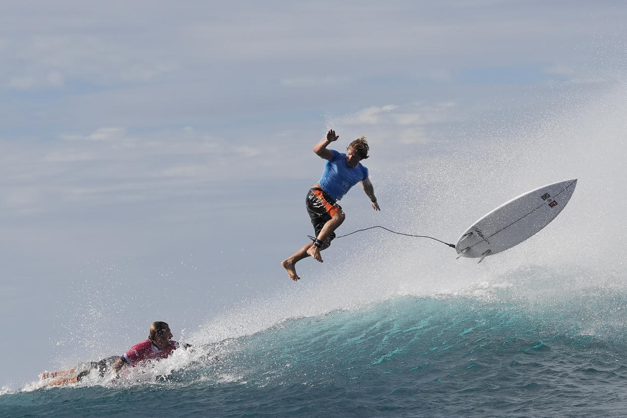 Alan Cleland Quinonez, top, kicks off a wave over Joan Duru