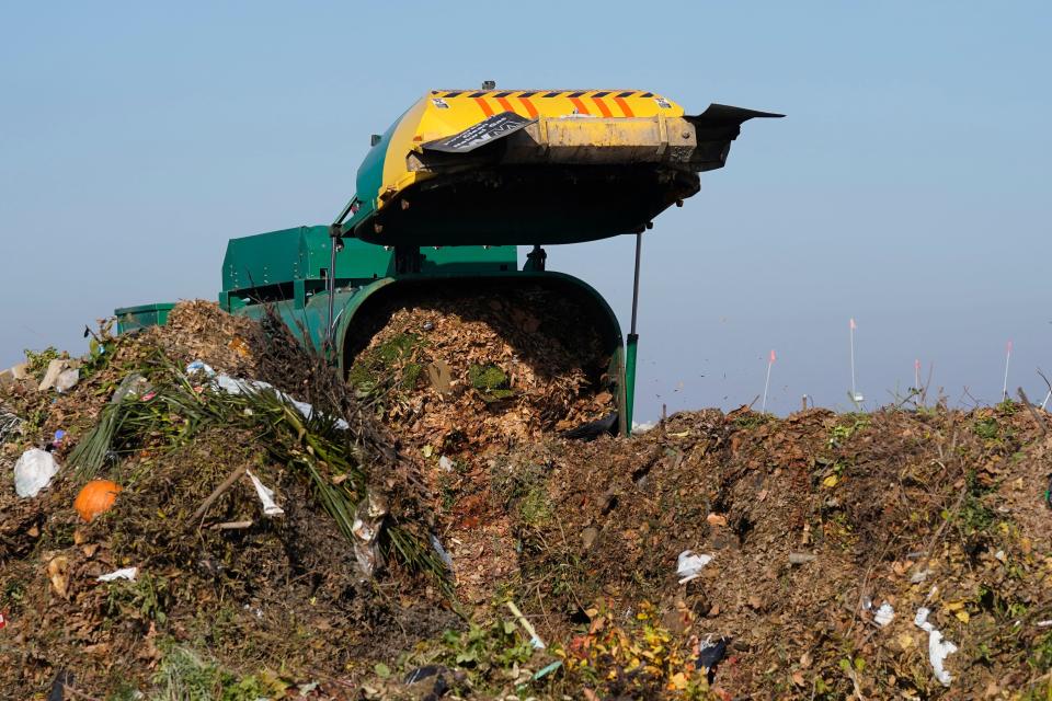 A truck unloads organic waste to be used for composting at the Anaerobic Composter Facility in Woodland, Calif., Tuesday, Nov. 30, 2021. In January 2022, new rules take effect in California requiring people to recycle organic waste like food and cardboard boxes so they can be turned into compost or energy. The goal is to reduce greenhouse gas emissions from landfills.