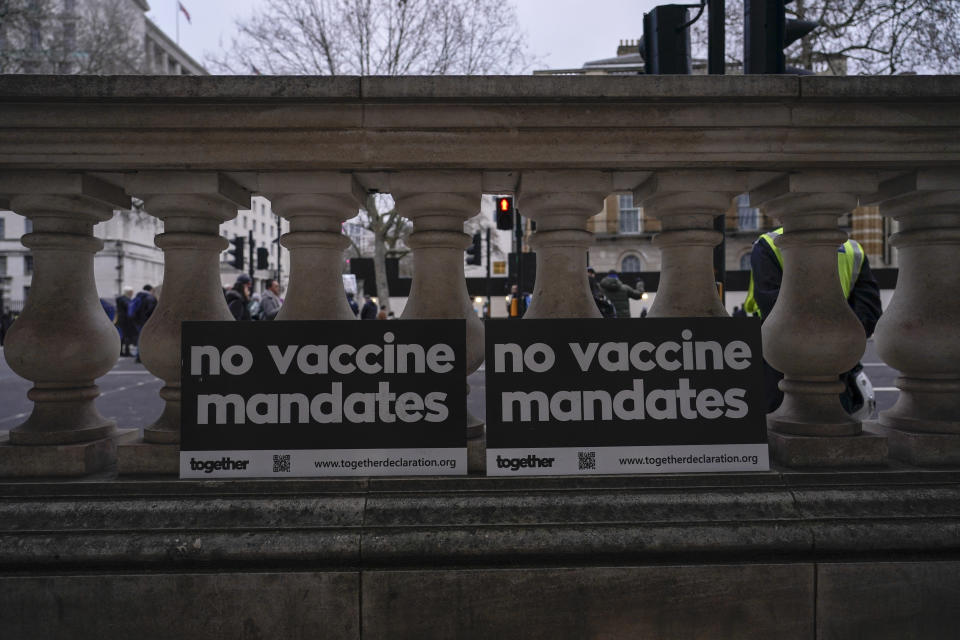 Placards reading 'no vaccine mandates' lie against a wall during an anti vaccines protest, in London, Saturday, Jan. 22, 2022.(AP Photo/Alberto Pezzali)