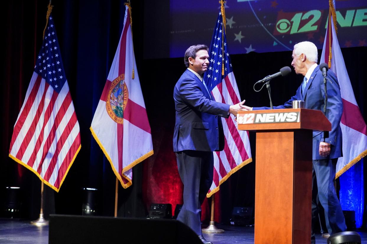 Florida's Republican incumbent Gov. Ron DeSantis and Charlie Crist, a former governor, take the stage at Sunrise Theatre for their only scheduled debate, Monday, Oct. 24, 2022, in Fort Pierce.