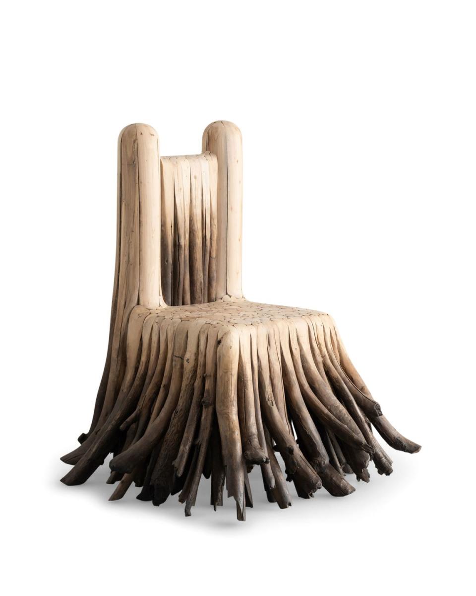 wood chair with back and drapes that look like tree roots coming from the seat base and back