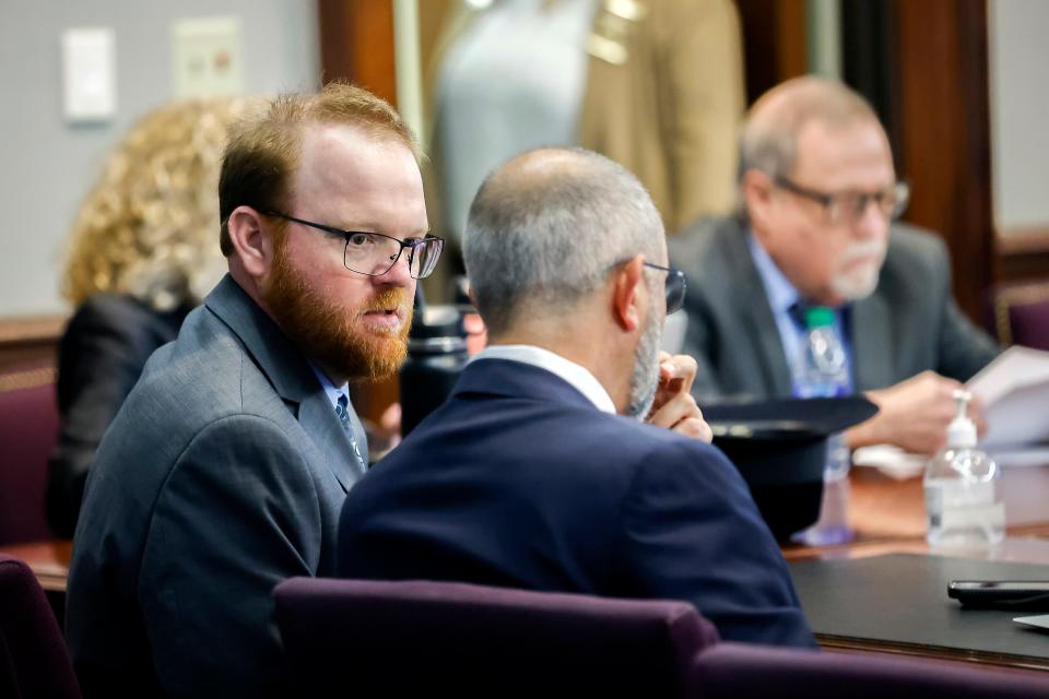 Travis McMichael, left, speaks with his attorney Jason B. Sheffield , center, during his sentencing, alone with his father Greg McMichael and neighbor, William "Roddie" Bryan in the Glynn County Courthouse, Friday, Jan. 7, 2022, in Brunswick, Ga. (AP Photo/Stephen B. Morton, Pool)