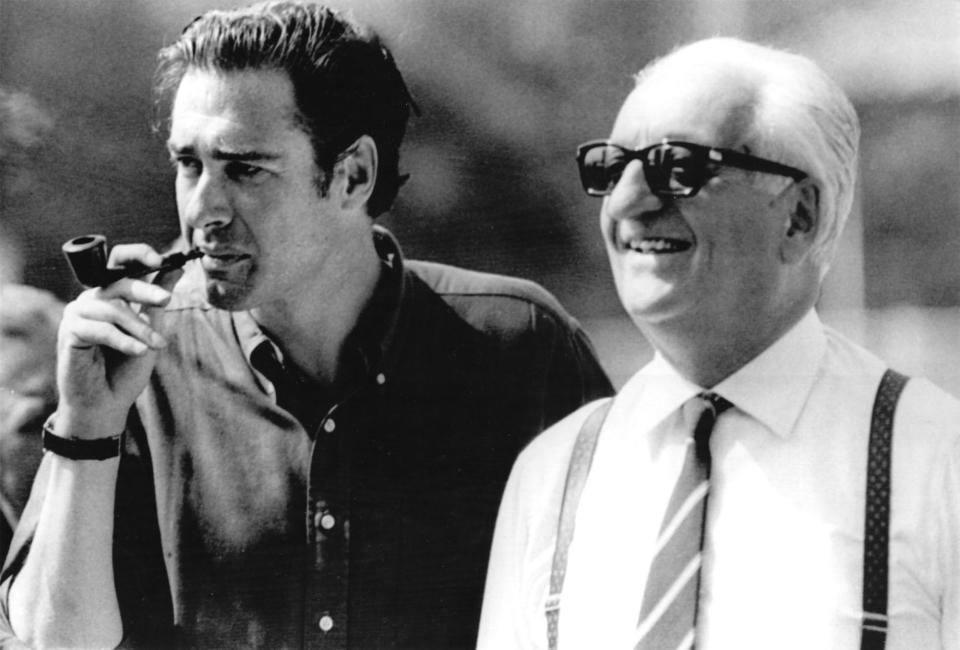 Movie director John Frankenheimer, left, and Enzo Ferrari, right, owner of Italian car factory pictured at Monza autodrome during a pause of "Grand Prix" shooting, August 23, 1966. (AP-PHOTO/Armando Trovati)