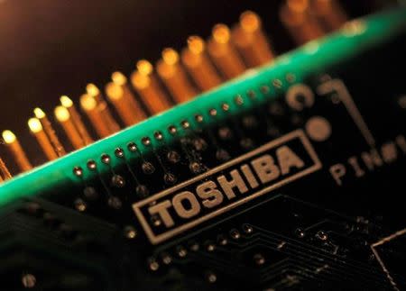FILE PHOTO: A logo of Toshiba Corp is seen on a printed circuit board in this photo illustration taken in Tokyo July 31, 2012. REUTERS/Yuriko Nakao/File Photo