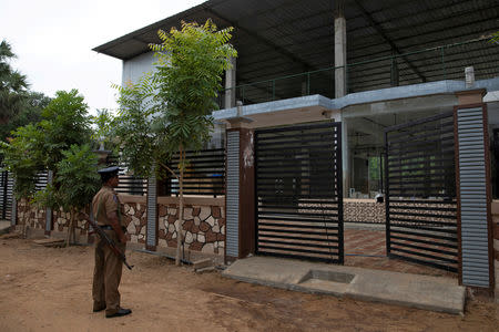 FILE PHOTO: A policeman stands guard outside the sealed office of National Tawheed Jamaath (NTJ), a banned Islamist group in Kattankudy, Sri Lanka, May 6, 2019. REUTERS/Danish Siddiqui/File Photo