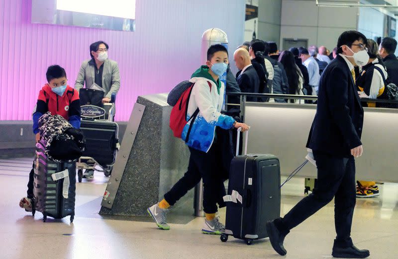 FILE PHOTO: Passengers arrive at LAX from Shanghai, China