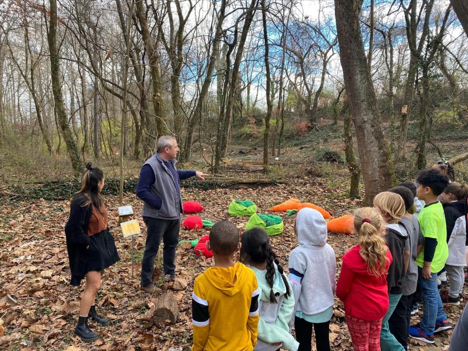 UT student  Oralia (Rilie) Rose-Mariea Acosta, left, and Jason Brown, a UT associate professor of art - sculpture, talk to students about Amanda McDonald’s "Veggie Garden" sculpture on the Dogwood Community Trail, Nov. 28, 2022.