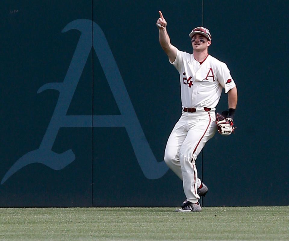 Arkansas centerfielder Braydon Webb (24) signals to his teammates after he made the final out and secured the series win during the Razorbacks' SEC conference game against Ole Miss baseball on May 1, 2022, at Baum-Walker Stadium in Fayetteville, Arkansas.