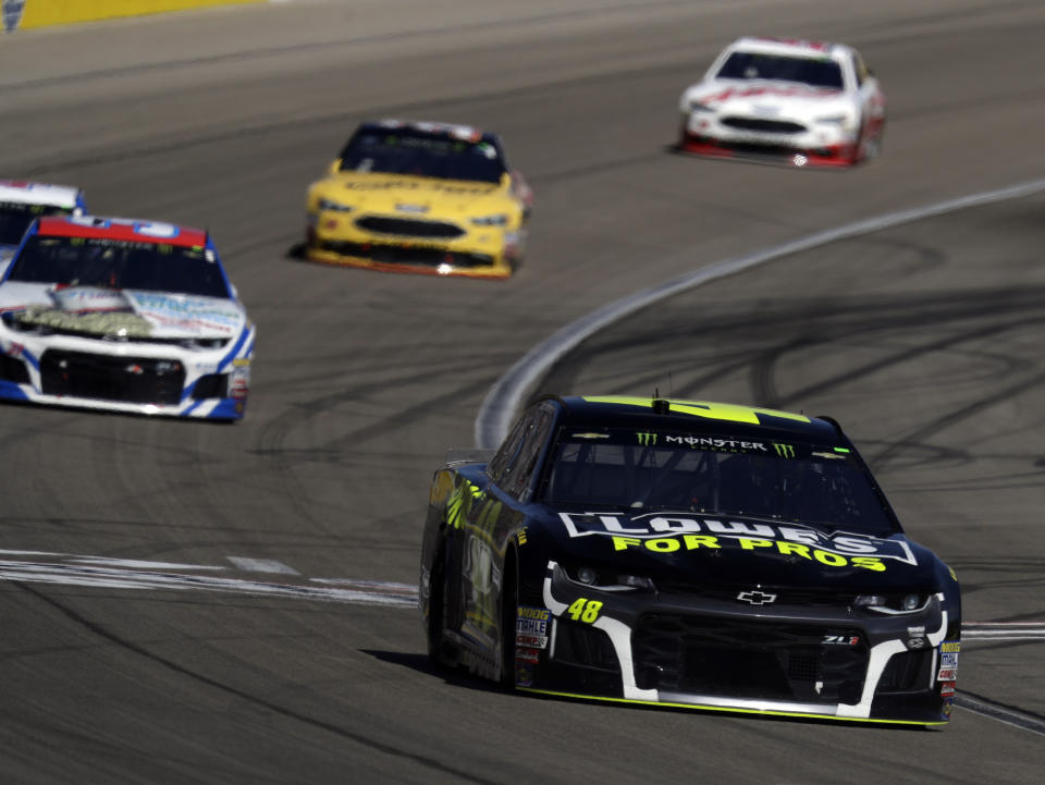 Jimmie Johnson, right, drives during a NASCAR Cup series auto race Sunday, March 4, 2018, in Las Vegas. (AP Photo/Isaac Brekken)
