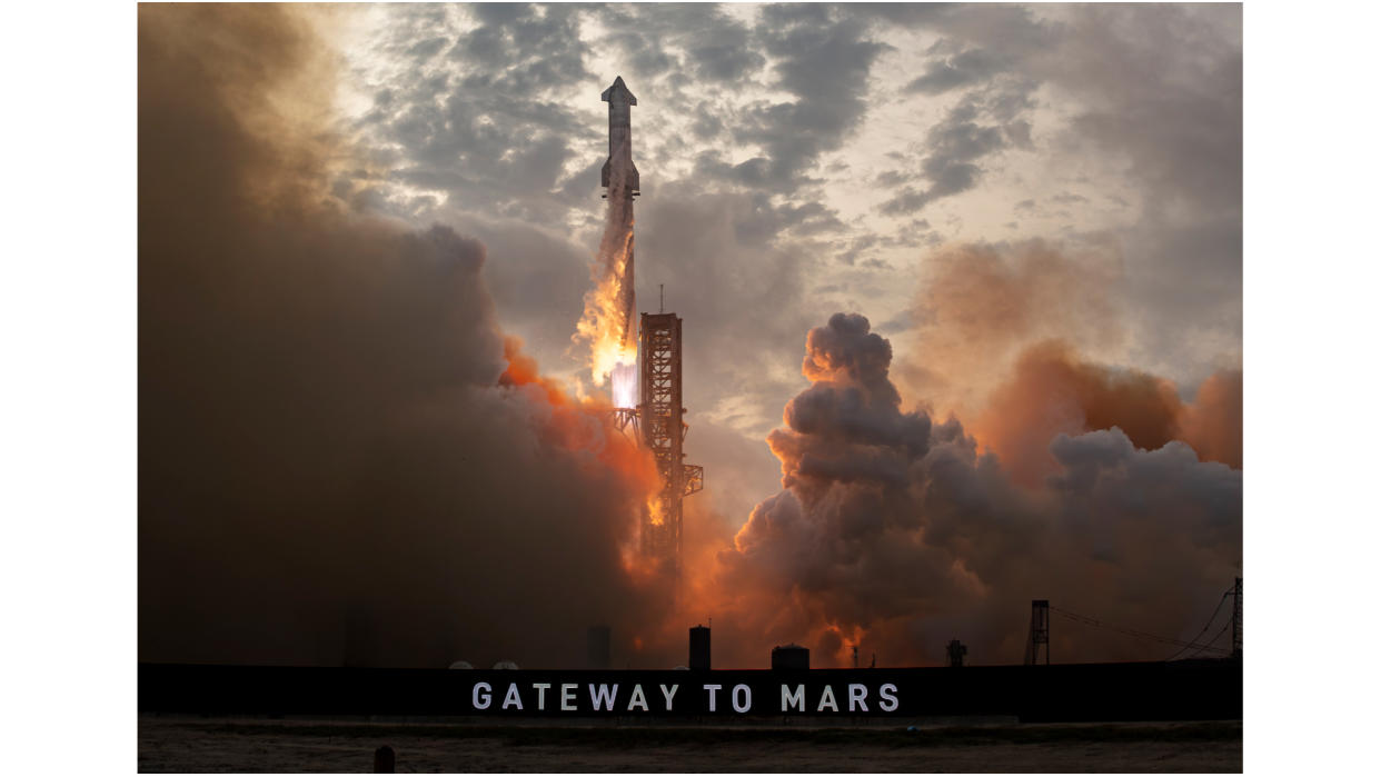  A huge silver rocket launches into a cloudy sky above a sign that reads "gateway to mars". 