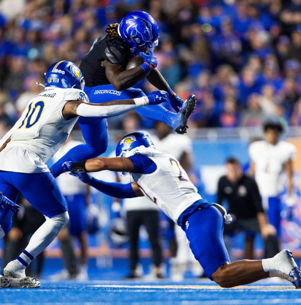 Boise State running back Ashton Jeanty hurdles San Jose State safety Tre Jenkins to convert on fourth down in the fourth quarter Saturday at Albertsons Stadium.