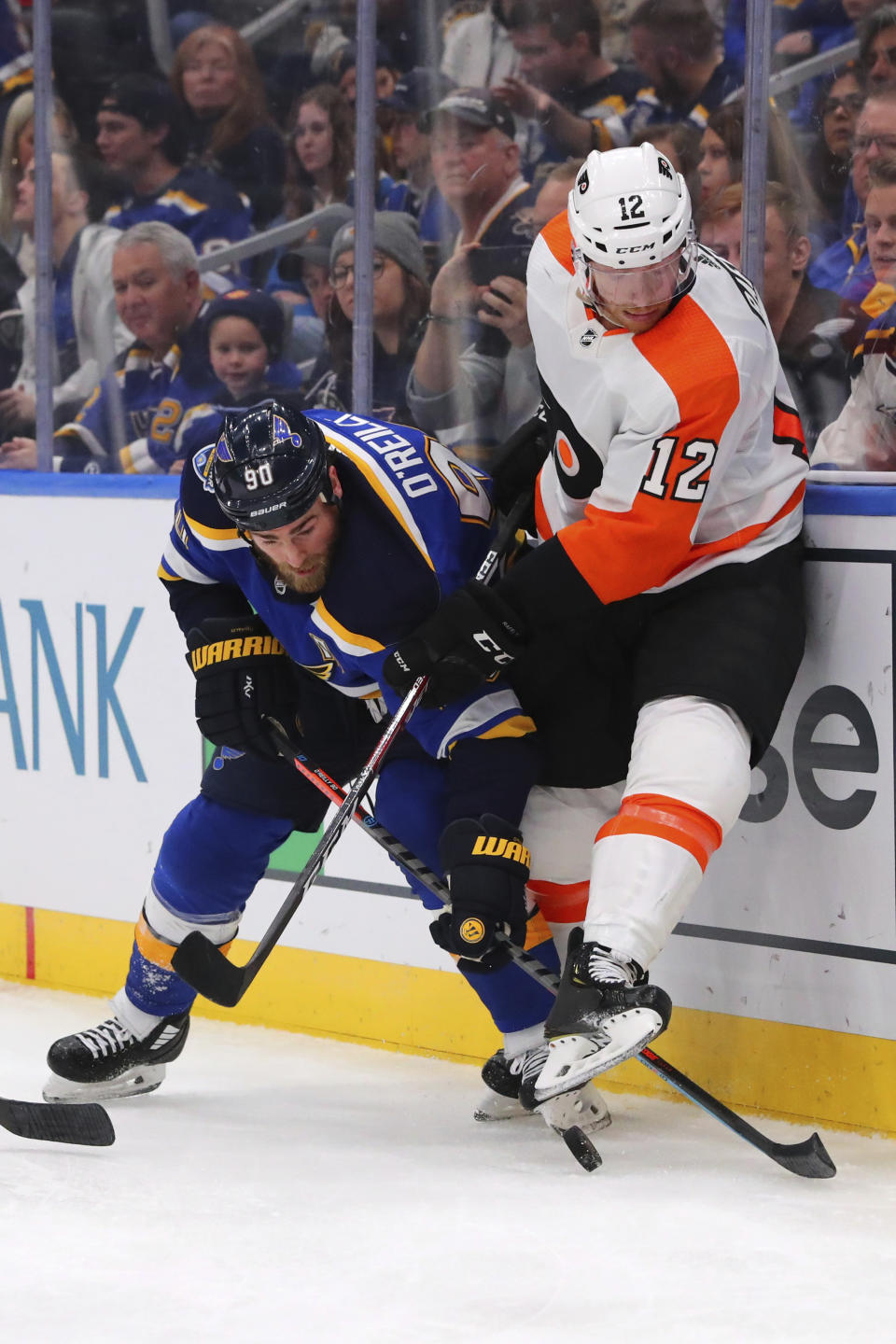 St. Louis Blues center Ryan O'Reilly (90) fights Philadelphia Flyers forward Michael Raffl (12) of Austria during the second period of an NHL hockey game Wednesday, Jan. 15, 2020 in St. Louis. (AP Photo/Dilip Vishwanat)