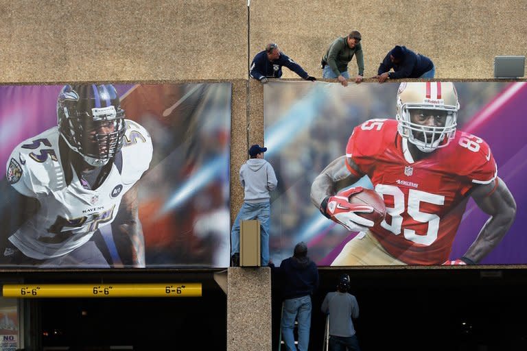 Workers install signs at the Superdome in New Orleans on January 31, 2013. New Orleans will return to the center of US sport's grandest stage by hosting Super Bowl 47 on Sunday, a milestone on the city's road to recovery from Hurricane Katrina