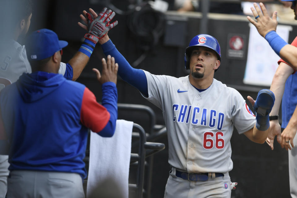 Chicago Cubs' Rafael Ortega celebrates with teammates in the dugout after scoring on a fielding error by Chicago White Sox third baseman Jake Burger during the seventh inning of a baseball game at Guaranteed Rate Field, Sunday, May 29, 2022, in Chicago. (AP Photo/Paul Beaty)