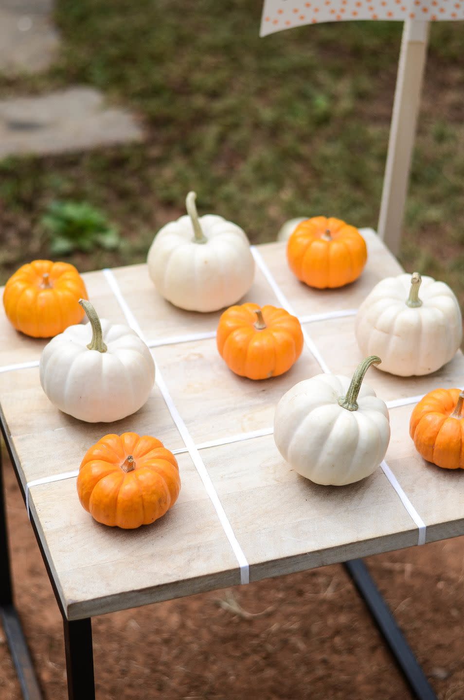 <p>Use mini pumpkins as the pieces (one color for Xs, and another for the Os) for this spirited take on the classic kids' game. </p><p><strong>Get the tutorial at <a href="https://www.ironandtwine.com/blog/toddler-party-games" rel="nofollow noopener" target="_blank" data-ylk="slk:Iron & Twine;elm:context_link;itc:0;sec:content-canvas" class="link ">Iron & Twine</a>.</strong></p><p><strong><a class="link " href="https://www.amazon.com/SAMYO-Decoration-Artificial-Simulation-Decoration-Set/dp/B01GDNLG46?tag=syn-yahoo-20&ascsubtag=%5Bartid%7C10050.g.3476%5Bsrc%7Cyahoo-us" rel="nofollow noopener" target="_blank" data-ylk="slk:SHOP MINI PUMPKINS;elm:context_link;itc:0;sec:content-canvas">SHOP MINI PUMPKINS</a><br></strong></p>