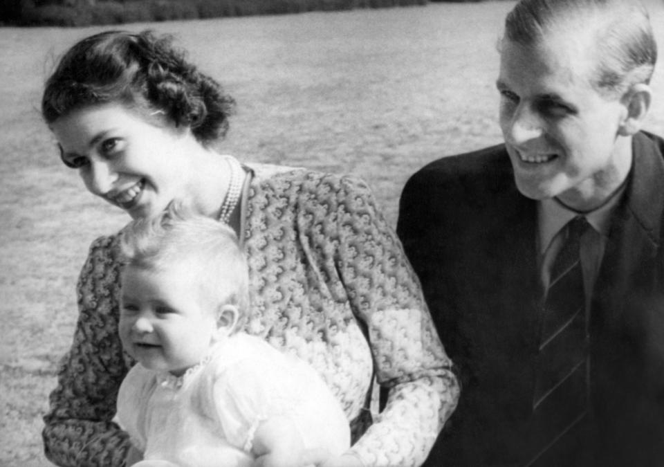 <p>Elizabeth and Philip with eight-month-old Charles in the grounds of Windlesham Moor, Surrey, on 18 July 1949. (PA Images via Getty Images)</p> 