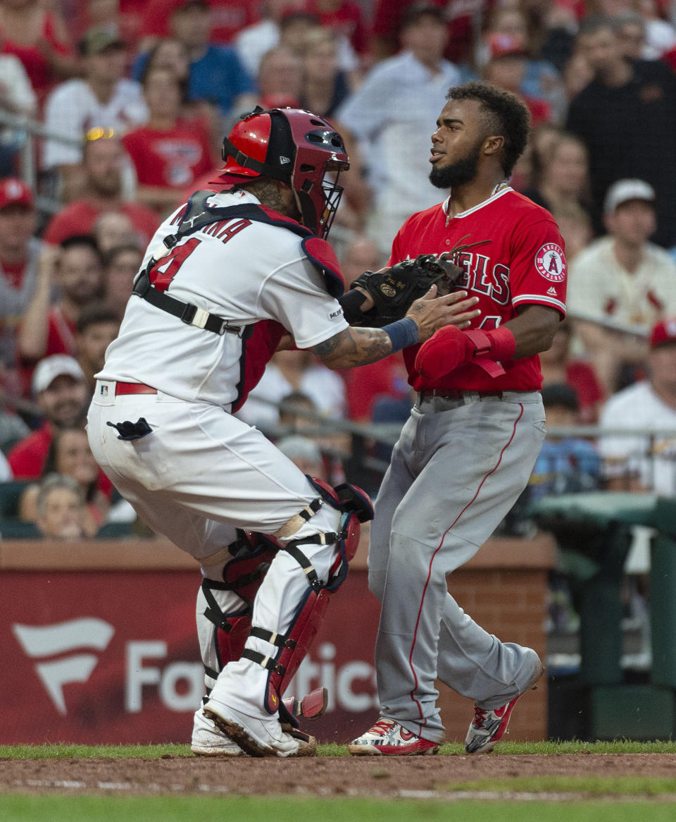 Los Angeles Angels' Luis Rengifo, right, is tagged out at home by St. Louis Cardinals catcher Yadier Molina, left, during the sixth inning of a baseball game Sunday, June 23, 2019, in St. Louis. (AP Photo/L.G. Patterson)