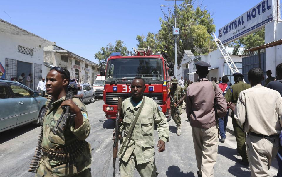 Somali security agents are seen outside the Central Hotel after a suicide attack in Somalia's capital Mogadishu February 20, 2015. Islamist rebels detonated a car bomb at the entrance of a hotel in the Somali capital on Friday and then stormed inside where politicians had gathered, killing at least 10 people including a lawmaker and lightly wounding two ministers. (REUTERS/Feisal Omar)