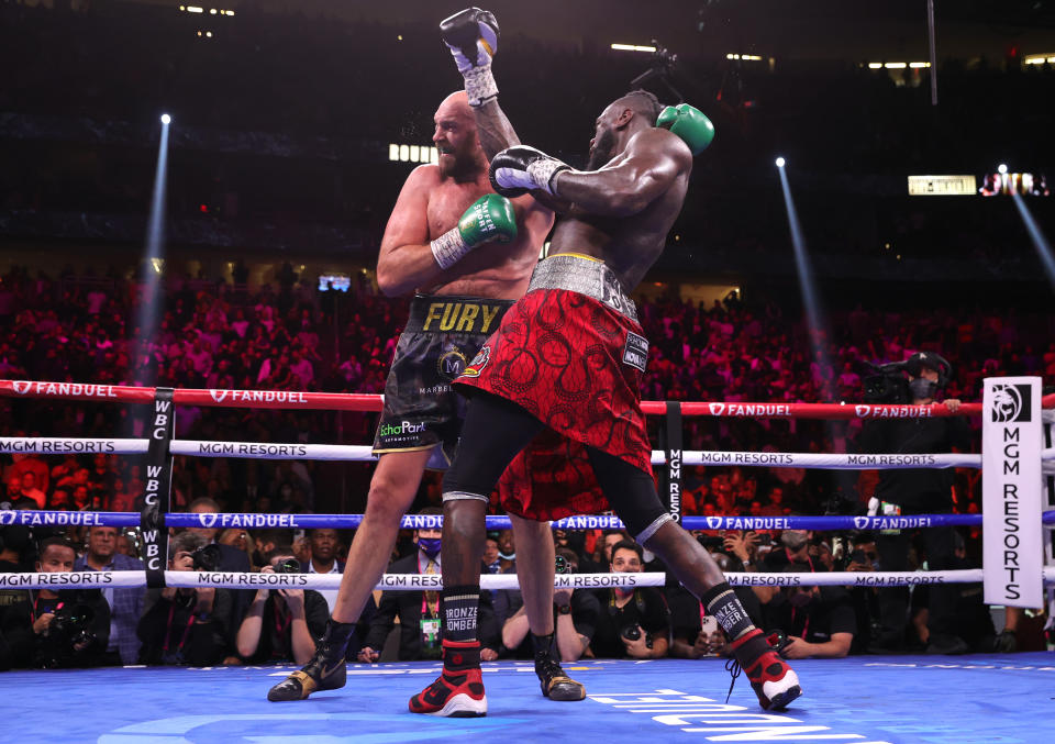 LAS VEGAS, NEVADA - OCTOBER 09: Tyson Fury (L) and Deontay Wilder (R) exchange punches during their fight for the WBC heavyweight championship at T-Mobile Arena on October 09, 2021 in Las Vegas, Nevada. (Photo by Mikey Williams/Top Rank Inc via Getty Images)