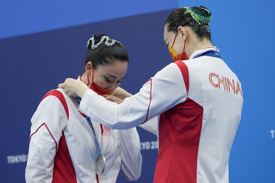 Second placed Huang Xuechen and Sun Wenyan of China wear their medals during the podium of the duet free routine final at the the 2020 Summer Olympics, Wednesday, Aug. 4, 2021, in Tokyo, Japan. (AP Photo/Alessandra Tarantino)