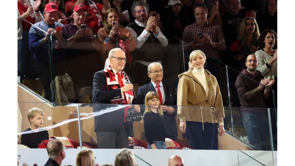 Charlene at basketball stands with husband and twins