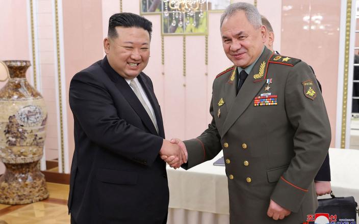 Kim Jong-un (left) and Sergei Shoigu shaking hands at the office building of the Party Central Committee in Pyongyang