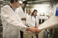 Britain's Home Secretary Priti Patel meets students and staff working on 'carbon capture' at Imperial College London in South Kensington, London, Tuesday Feb. 18, 2020. Britain has announced a new post-Brexit “points-based immigration system” said Patel, that will assess prospective immigrants on a range of skills, qualifications, salaries or professions, starting next year. (Stefan Rousseau/PA via AP)