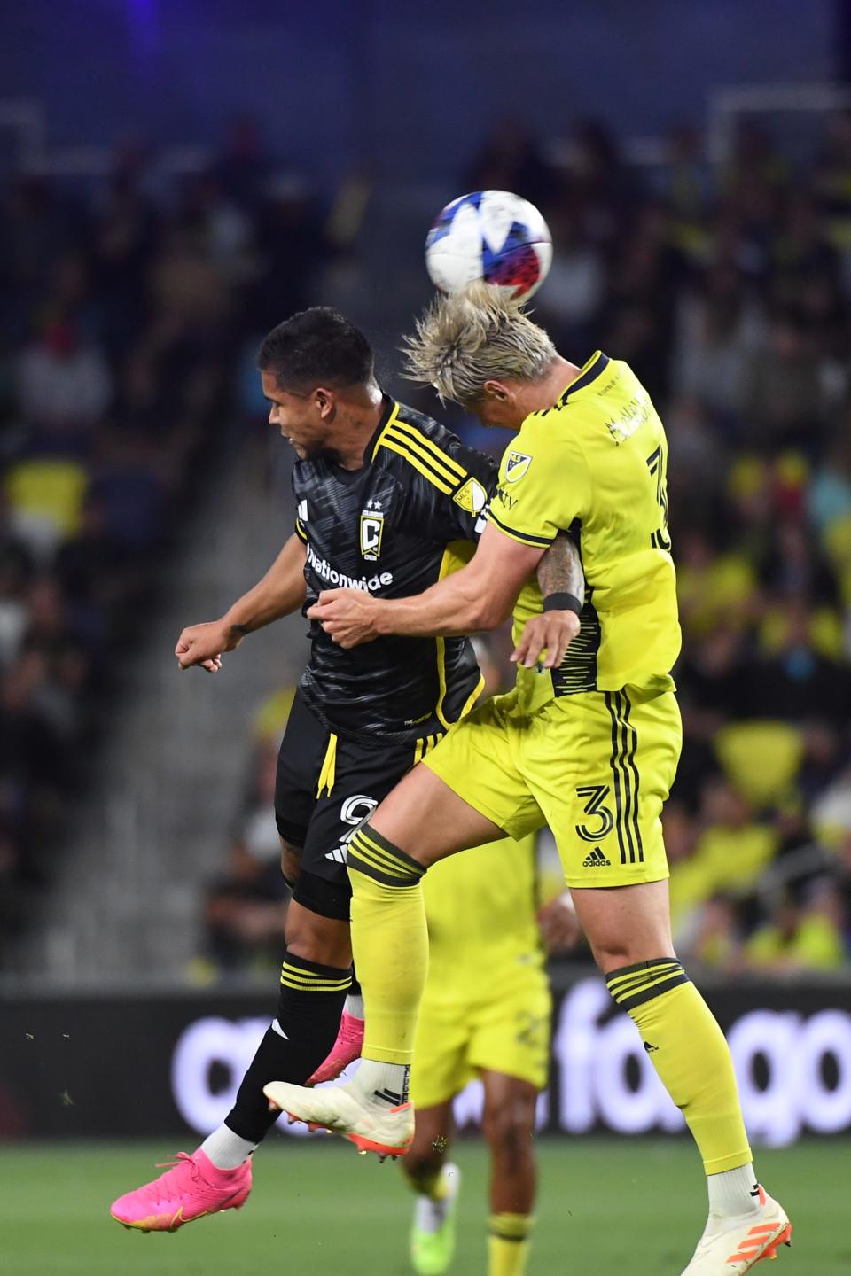 May 28, 2023; Nashville, Tennessee, USA; Nashville SC defender Lukas MacNaughton (3) heads the ball against the Columbus Crew forward Cucho Hernandez (9) during the first halfat Geodis Park. Mandatory Credit: Christopher Hanewinckel-USA TODAY Sports