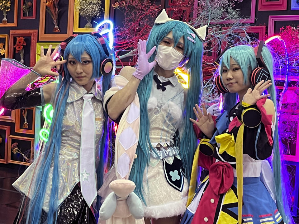 Fans of Japan’s Vocaloid Hatsune Miku gather at a Tokyo suburb hall, Makuhari Messe, in Chiba, Japan, Friday, Sept. 1, 2023 to celebrate Miku’s 16th birthday with a concert and other events. Hatsune Miku has always been 16 years old and worn long aqua ponytails. She is Japan's most famous Vocaloid, a computer-synthesized singing voice software that, in her case, comes with a virtual avatar. (AP Photo/Yuri Kageyama)