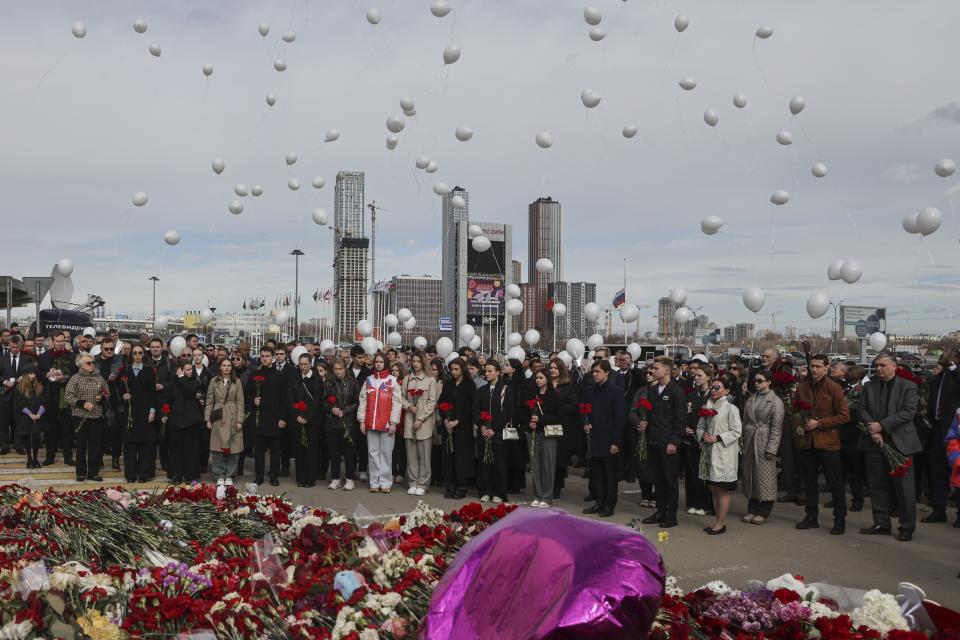 A group of ambassadors of foreign diplomatic missions attend a laying ceremony at a makeshift memorial in front of the Crocus City Hall on the western outskirts of Moscow, Russia, Saturday, March 30, 2024. (Sergei Ilnitsky/Pool Photo via AP)