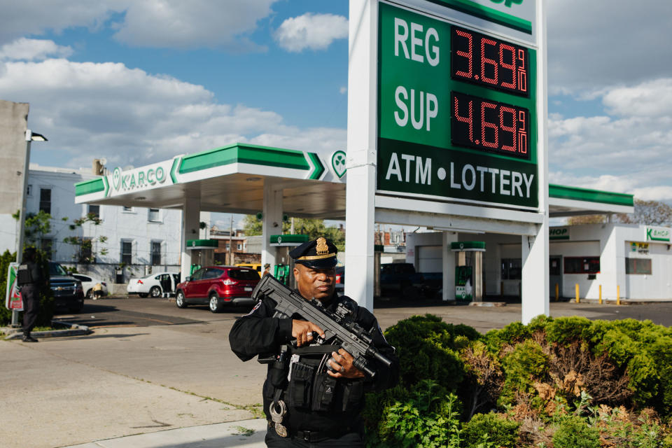 Andre Boyer, an agent for the Strategic Intervention Tactical Enforcement (S.I.T.E.), is seen patrolling the sidewalk outside of a Karco gas station in North Philadelphia, Pa., armed with a Bullpup shotgun, on April 24, 2023.