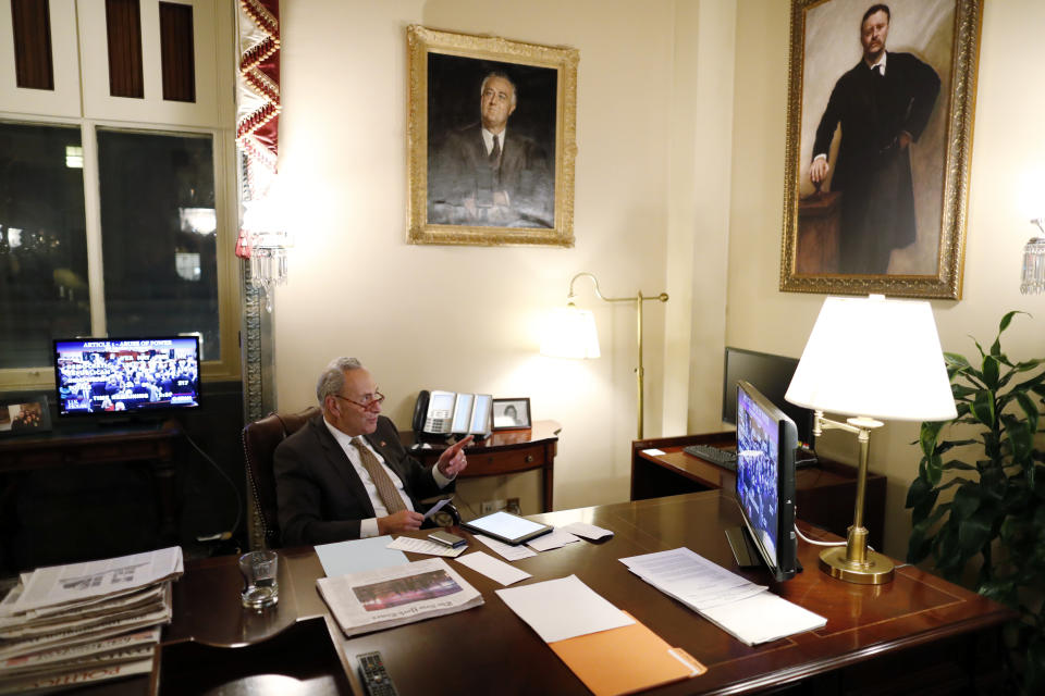 Senate Minority Leader Sen. Chuck Schumer of N.Y., watches from his Senate office as the House votes on the articles of impeachment President Donald Trump, Wednesday, Dec. 18, 2019, on Capitol Hill in Washington. (AP Photo/Andrew Harnik)