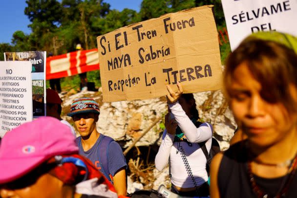 PHOTO: A protestor holds a sign as activists and locals protest the environmental impact of the new Mayan Train route, outside the Yorogana cave in Playa del Carmen, Quintana Roo, Mexico, November 5, 2022. (Jose Luis Gonzalez/Reuters)