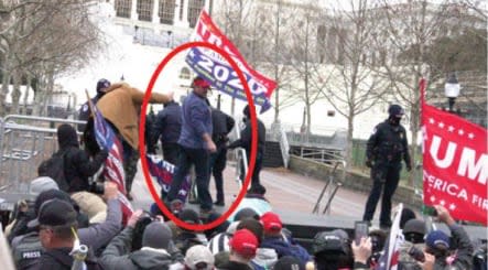 Screenshots from an open source video showing Schubert (circled in red) after breaching police barriers