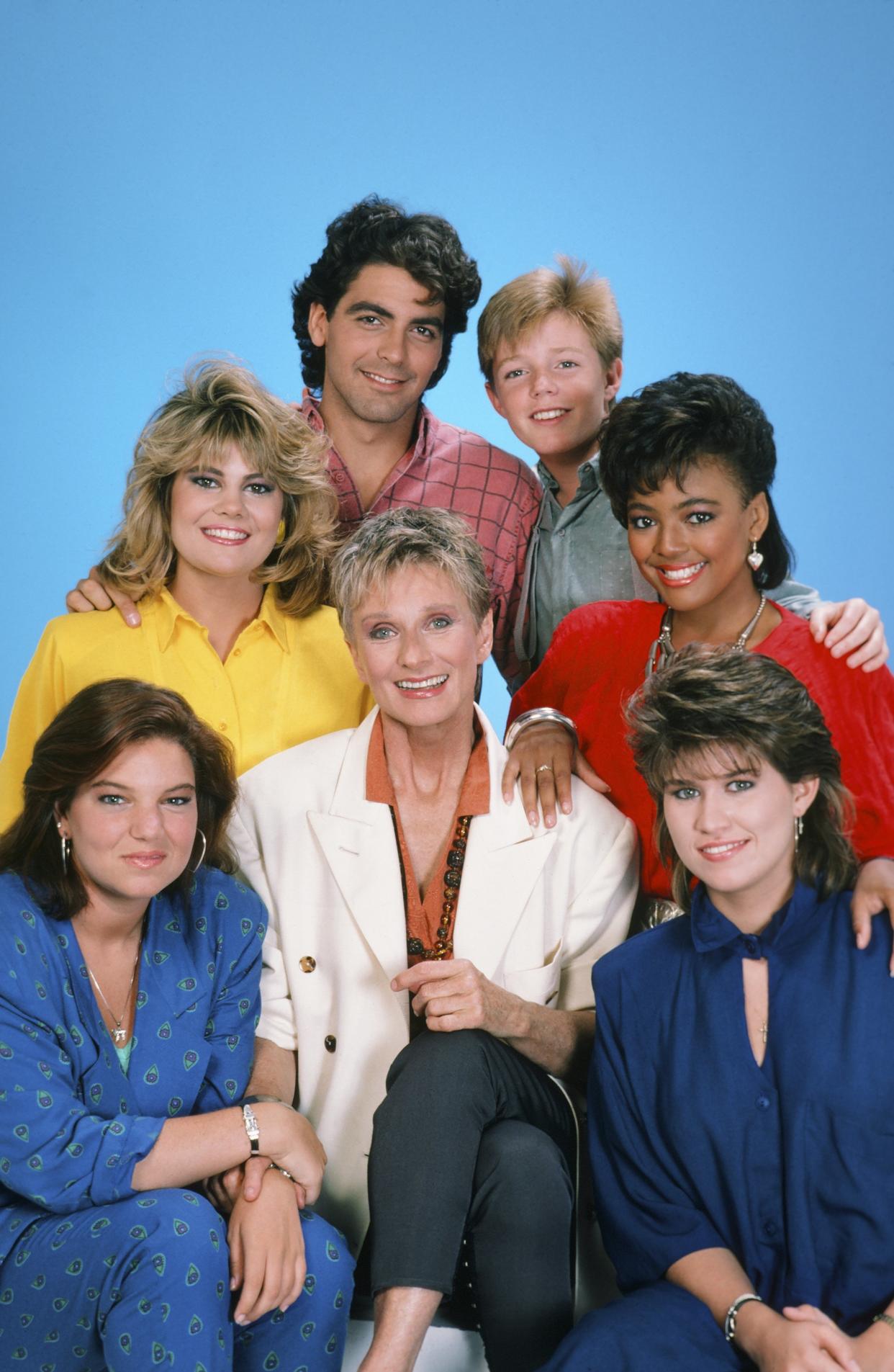 THE FACTS OF LIFE -- Season 8 -- Pictured: (clockwise from bottom left) Mindy Cohn as Natalie Letisha Sage Green, Lisa Whelchel as Blair Warner, George Clooney as George Burnett, Mackenzie Astin as Andy Moffet Stickle, Nancy McKeon as Joanna 'Jo' Marie Polniaczek Bonner, Kim Fields as Dorothy 'Tootie' Ramsey (center) Cloris Leachman as Beverly Ann Stickle -- Photo by: Gary Null/NBC/NBCU Photo Bank