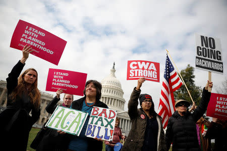 Protestors chant during a rally against the Republican tax bill on Capitol Hill in Washington U.S., November 15, 2017. REUTERS/Aaron P. Bernstein