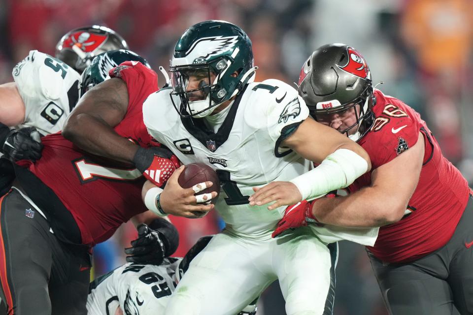Philadelphia Eagles quarterback Jalen Hurts (1) gets sacked by Tampa Bay Buccaneers defensive tackle Greg Gaines (96) during an NFL wild-card playoff football game, Monday, Jan. 15, 2024 in Tampa, Fla.