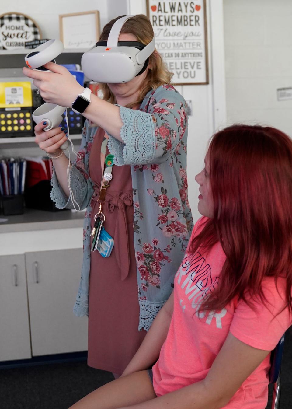 Britton Deerfield Schools math teacher Emily Spohn checks out seventh grader Alexis Granby’s VR set up.