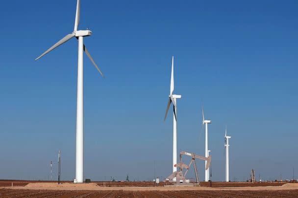 PHOTO: An oil pump jack works near wind turbines in the Permian Basin oil field on March 11, 2022 in Stanton, Texas. (Joe Raedle/Getty Images, FILE)