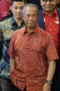 In this Feb. 23, 2020, photo, Muhyiddin Yassin, president of Malaysian United Indigenous Party walks out after a private meeting at a hotel in Kuala Lumpur, Malaysia. Bersatu party said in a statement Friday, Feb. 28, 2020 that 36 lawmakers, including nearly a dozen who defected from Anwar Ibrahim's party, have decided to support party President Muhyiddin Yassin instead of Mahathir as prime minister. (AP Photo/Vincent Thian)