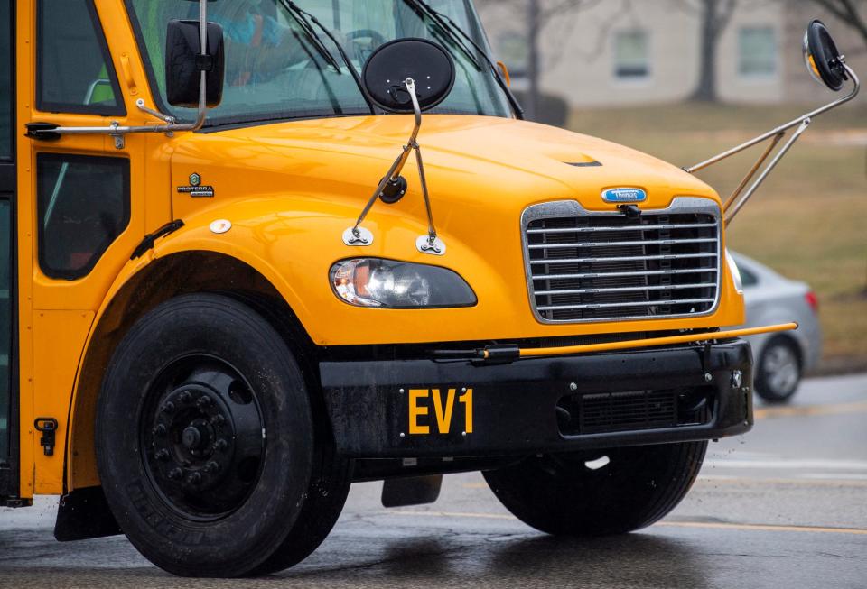 The "EV1" marking can be seen on an electric school bus as it heads down Walnut Street towards Bloomington High School South on Tuesday, Jan. 23, 2024.