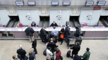 Passengers check in for a flight to Reykjavik, Iceland, at Scotland's Glasgow Airport in April 2010. Iceland hopes its certificate for those vaccinated against COVID-19 will reduce barriers to travel but other countries feel it's much too soon. (AFP via Getty Images)