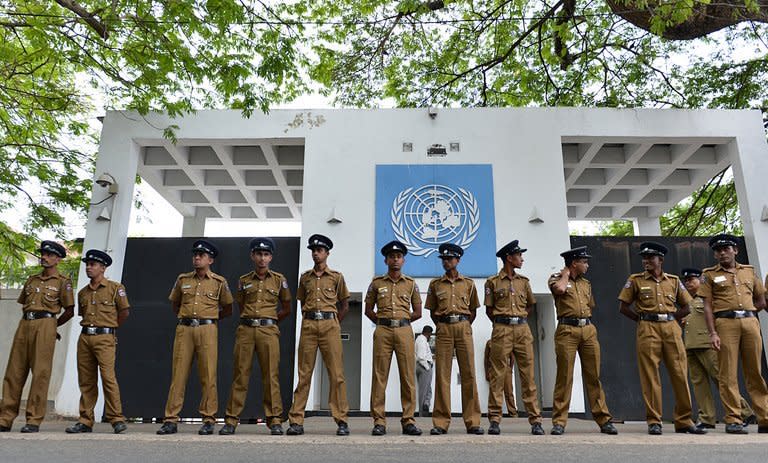 Sri Lankan police officials stand guard outside the United Nations office in Colombo on August 26, 2013. A Catholic-run human rights group working in northeastern Sri Lanka said Monday it had been harassed by security personnel after meeting UN rights chief Navi Pillay last week