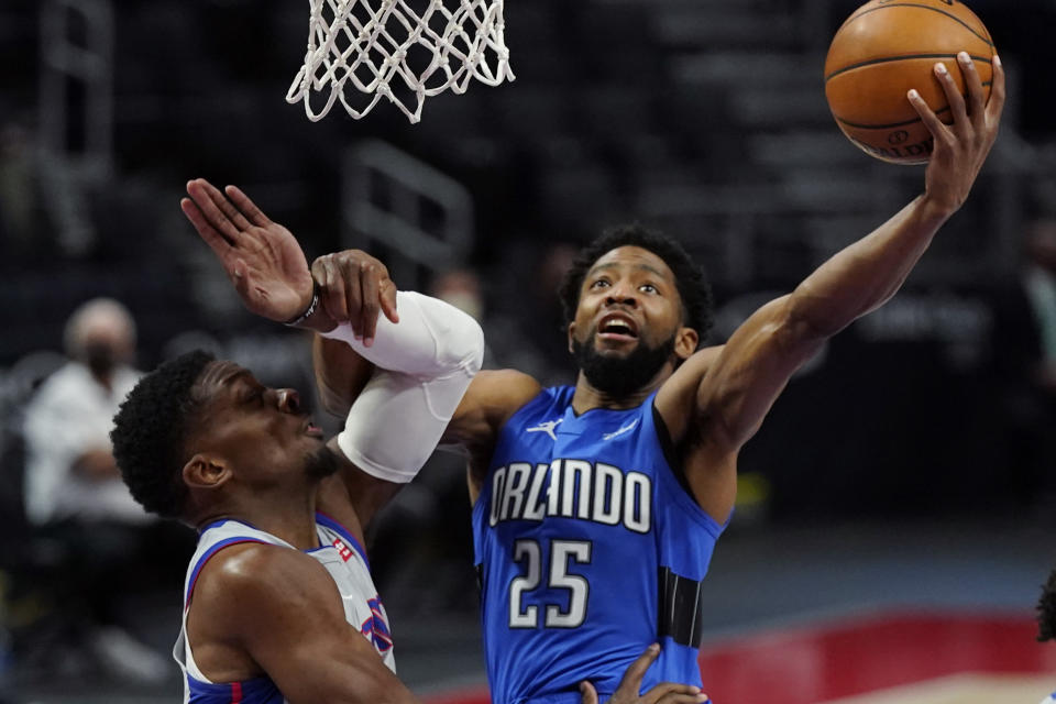 Orlando Magic guard Chasson Randle (25) makes a layup as Detroit Pistons forward Tyler Cook defends during the second half of an NBA basketball game, Monday, May 3, 2021, in Detroit. (AP Photo/Carlos Osorio)