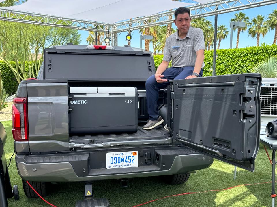 Ford F-150 chief engineer Milton Wong demonstrates the pickup's new Pro Access tailgate, which improves bed access.