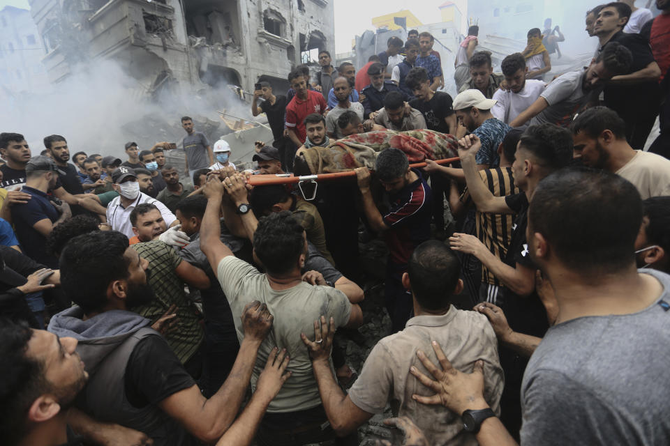 Palestinians remove a dead body from the rubble of a building following an Israeli airstrike on the Jabalia  refugee camp in the Gaza Strip on Monday. (Ramez Mahmoud/AP )