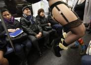 RNPS - PICTURES OF THE YEAR 2013 - People watch as participants in the No Pants Subway Ride take the 6 train downtown in New York January 13, 2013. The event is an annual flash mob and occurs in different cities around the world, according to its organisers. REUTERS/Carlo Allegri (UNITED STATES - Tags: SOCIETY TPX)